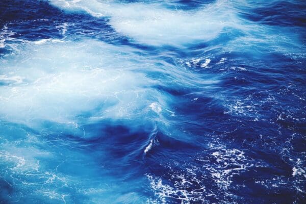 Blue ocean waves with white foam
