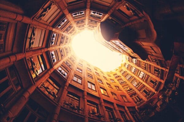 Looking up at sunlit circular courtyard