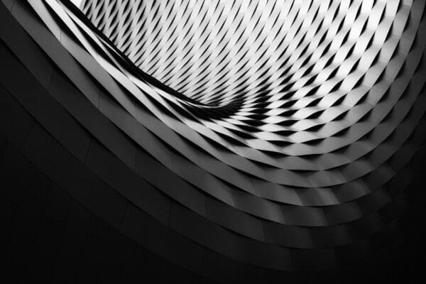 Curved repeating architectural panels in grayscale